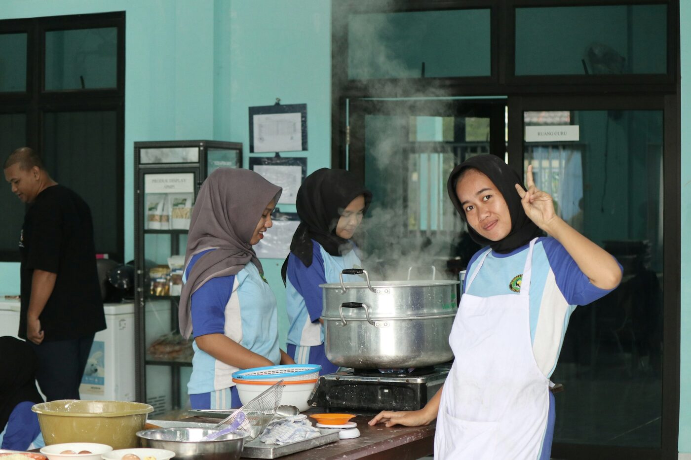 Hospitality students at a steamer in a training kitchen