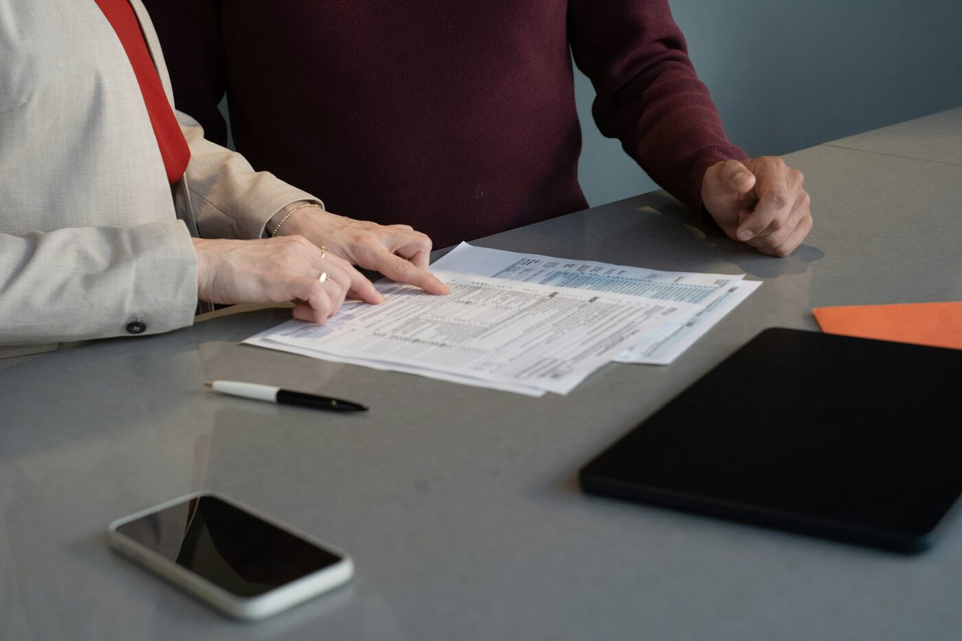 Two people reviewing a document together at a table